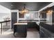 Modern kitchen featuring stainless steel appliances, a butcher block island, and black cabinetry at 96 S Lindsey St, Castle Rock, CO 80104