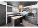 Eat-in kitchen features an island, stainless steel appliances, and modern backsplash at 96 S Lindsey St, Castle Rock, CO 80104