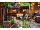 Inviting back patio with a hot tub, comfortable seating, grill, and lush greenery, perfect for outdoor entertaining at 1121 S Williams St, Denver, CO 80210