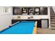 Basement featuring a pool table, built-in shelving, and a beverage fridge at 1121 S Williams St, Denver, CO 80210