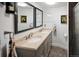 Bright bathroom with a double sink vanity, framed mirrors, neutral walls and tile flooring at 1121 S Williams St, Denver, CO 80210