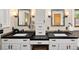 Bathroom with dual sinks, dark countertops, modern fixtures, and white cabinetry at 1121 S Williams St, Denver, CO 80210