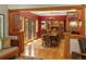 Formal dining room with hardwood floors and wood furniture next to beautiful red walls at 1121 S Williams St, Denver, CO 80210