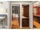 Hallway with hardwood floors leading to kitchen, pantry, and dining room at 1121 S Williams St, Denver, CO 80210