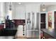 Kitchen with stainless refrigerator, wine rack, and dark countertops at 1121 S Williams St, Denver, CO 80210
