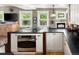 Bright kitchen with black countertops, white cabinets and stainless steel oven at 1121 S Williams St, Denver, CO 80210