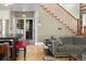 Open living space with hardwood floors that connects to the kitchen and stairway at 1121 S Williams St, Denver, CO 80210