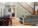 Living room with stairs to upper level, connecting to kitchen and hardwood floors at 1121 S Williams St, Denver, CO 80210