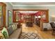 Spacious living room with red accent wall boasts beautiful hardwood floors and a window at 1121 S Williams St, Denver, CO 80210