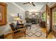 Cozy living room with a fireplace, hardwood floors, stylish furnishings, and abundant natural light at 1121 S Williams St, Denver, CO 80210