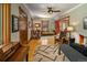 Cozy living room boasts warm hardwood floors, ceiling fan, and neutral-toned walls at 1121 S Williams St, Denver, CO 80210