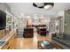 Open-concept living room with hardwood floors and a view into the modern kitchen at 1121 S Williams St, Denver, CO 80210