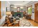 Bright living room features hardwood floors, a fireplace, comfortable seating, and charming decor at 1121 S Williams St, Denver, CO 80210