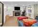 Basement living room with a brick fireplace, large TV, and comfortable seating at 1121 S Williams St, Denver, CO 80210