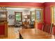 Inviting living room and dining room separated by wood trim and red accent walls at 1121 S Williams St, Denver, CO 80210