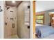 Walk-in shower featuring tiled walls and modern fixtures, adjacent to a bedroom at 1121 S Williams St, Denver, CO 80210