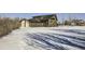 A remodeled home with a large backyard, snow-covered lawn, and attached garage at 4022 Arleigh Dr, Berthoud, CO 80513