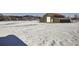 Snowy yard with barn and distant mountains at 4022 Arleigh Dr, Berthoud, CO 80513