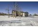 The back of the house showcasing a large deck and surrounding trees at 4022 Arleigh Dr, Berthoud, CO 80513