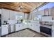 Modern kitchen with white cabinets, quartz countertops, and stainless steel appliances at 4022 Arleigh Dr, Berthoud, CO 80513