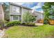 Beautiful backyard featuring green lawn, patio, garden beds, and mature trees at 359 Wessex Cir, Highlands Ranch, CO 80126