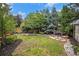 Expansive backyard featuring a lush lawn, mature trees, and a cozy seating area at 359 Wessex Cir, Highlands Ranch, CO 80126