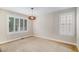 Bright empty room with large windows, neutral walls and natural wood trim at 359 Wessex Cir, Highlands Ranch, CO 80126