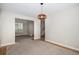 Empty room with hanging light fixture, neutral walls and natural wood trim at 359 Wessex Cir, Highlands Ranch, CO 80126