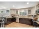 Well-lit kitchen with granite countertops, stainless steel appliances, hardwood floors, and a view of the dining area at 359 Wessex Cir, Highlands Ranch, CO 80126