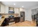Updated kitchen featuring granite countertops, stainless steel appliances, and ample cabinet space at 359 Wessex Cir, Highlands Ranch, CO 80126