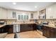 Bright kitchen with granite countertops, stainless steel appliances, hardwood floors, and custom cabinets at 359 Wessex Cir, Highlands Ranch, CO 80126