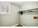 Bright laundry room featuring tile flooring, shelf and hookups for washer and dryer at 359 Wessex Cir, Highlands Ranch, CO 80126