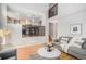 Open-concept living area featuring hardwood floors, neutral paint, and a view of the kitchen and upper level at 359 Wessex Cir, Highlands Ranch, CO 80126