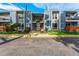 Condo building's exterior showcasing its light blue facade and landscaping at 2190 E Geddes Ave # E, Centennial, CO 80122