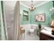 Quaint bathroom featuring elegant green walls, beadboard, and a glass enclosed shower at 1602 Glen Bar Dr, Lakewood, CO 80215