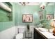 Charming bathroom featuring elegant green walls, beadboard, and unique fixtures at 1602 Glen Bar Dr, Lakewood, CO 80215