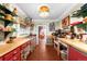 Unique kitchen with colorful cabinets, open shelving, and vintage decor creating a cheerful cooking space at 1602 Glen Bar Dr, Lakewood, CO 80215