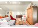 Spacious living room featuring a comfortable sofa, vintage decor, and lots of natural light at 1602 Glen Bar Dr, Lakewood, CO 80215