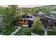 Stunning aerial view of a modern home nestled amongst lush greenery and mountain views at 2725 6Th St, Boulder, CO 80304
