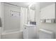 Bright bathroom featuring a tub with tile surround, a vanity, and a window at 2725 6Th St, Boulder, CO 80304