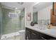 Modern bathroom featuring a glass-enclosed shower with green tile and a vanity with a white countertop at 2725 6Th St, Boulder, CO 80304