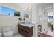 Bathroom with a dark wood vanity and a window providing natural light and views at 2725 6Th St, Boulder, CO 80304