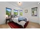 Cozy bedroom with three windows offering scenic views and stylish decor, including a red rug at 2725 6Th St, Boulder, CO 80304