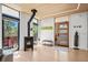 Light-filled entryway featuring hardwood floors, modern gas fireplace, and a contemporary door at 2725 6Th St, Boulder, CO 80304