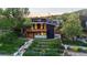 Modern two-story home with a wood balcony, stylish architecture, and tiered landscaping at 2725 6Th St, Boulder, CO 80304