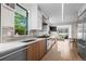 Modern kitchen featuring stainless steel appliances, wood cabinets, light countertops, and a bright, sunlit window at 2725 6Th St, Boulder, CO 80304