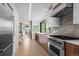 Bright, modern kitchen with stainless appliances, light countertops, wooden cabinets, and hardwood floors at 2725 6Th St, Boulder, CO 80304