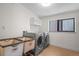 Functional laundry room featuring modern washer and dryer with a storage cabinet at 2725 6Th St, Boulder, CO 80304