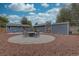 Spacious backyard with stone firepit area, mature trees, and well-maintained landscaping at 1275 S Wolff St, Denver, CO 80219