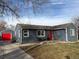 Charming home featuring a red door, well-maintained lawn, and a detached garage with a red door at 1275 S Wolff St, Denver, CO 80219